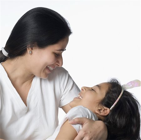 simsearch:630-02219943,k - Close-up of a mid adult woman smiling with her daughter Stock Photo - Premium Royalty-Free, Code: 630-02219739
