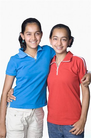Teenage girl smiling with her sister Stock Photo - Premium Royalty-Free, Code: 630-02219853