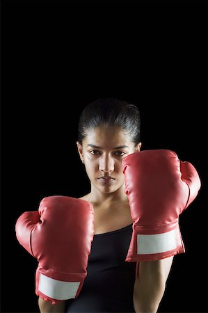 Portrait of a female boxer in boxing stance Stock Photo - Premium Royalty-Free, Code: 630-02219889