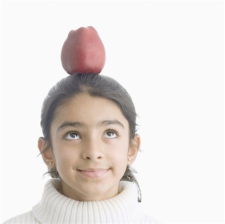 simsearch:630-02221120,k - Girl balancing an apple on her head and smiling Stock Photo - Premium Royalty-Free, Code: 630-02219954