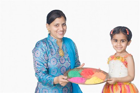 simsearch:630-02219943,k - Portrait of a mid adult woman and her daughter holding a plate of powder paint and smiling Stock Photo - Premium Royalty-Free, Code: 630-02219987