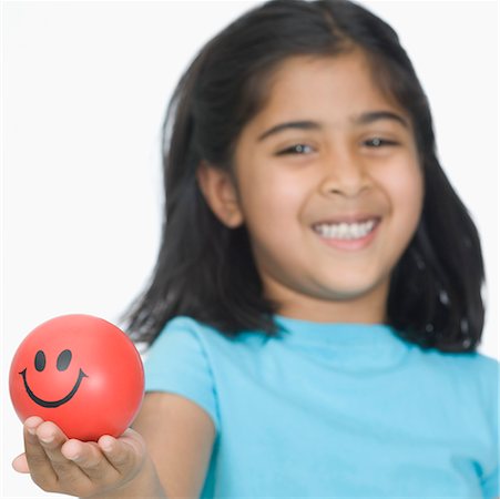 simsearch:630-02221120,k - Close-up of a girl showing a ball Stock Photo - Premium Royalty-Free, Code: 630-02220025