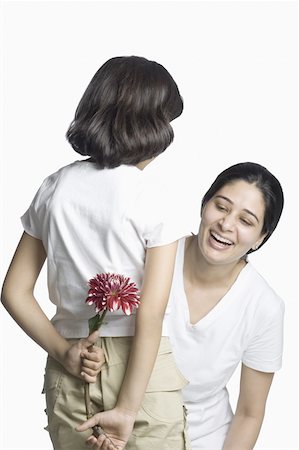 flower for mom asian - Rear view of a girl hiding a flower from her mother Stock Photo - Premium Royalty-Free, Code: 630-02220134