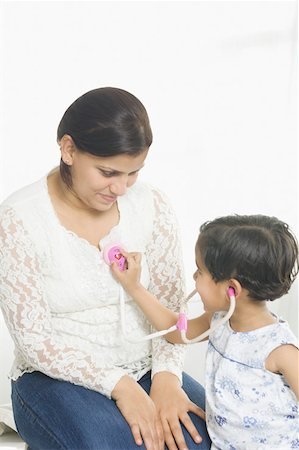 simsearch:630-02219943,k - Side profile of a girl examining her mother with a stethoscope and smiling Stock Photo - Premium Royalty-Free, Code: 630-02220179