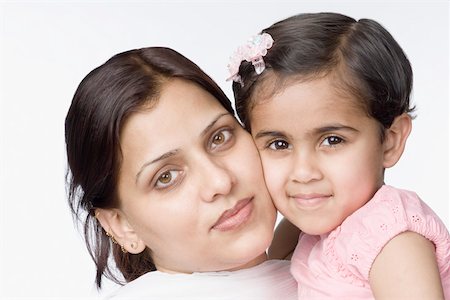 simsearch:630-02219943,k - Portrait of a mid adult woman cheek to cheek with her daughter and smiling Stock Photo - Premium Royalty-Free, Code: 630-02220189