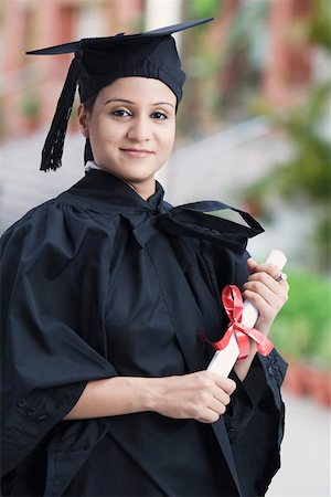 Portrait of a young female graduate holding a diploma Stock Photo - Premium Royalty-Free, Code: 630-02220226