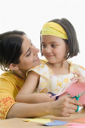 simsearch:630-02221120,k - Young woman with her daughter cutting papers with scissors Stock Photo - Premium Royalty-Free, Code: 630-02220318