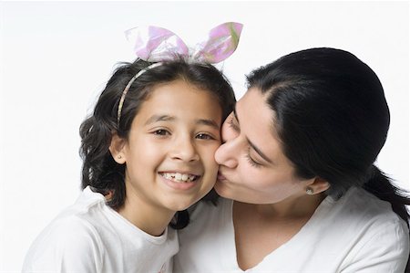 preteen kissing - Close-up of a mid adult woman kissing her daughter Stock Photo - Premium Royalty-Free, Code: 630-02220325