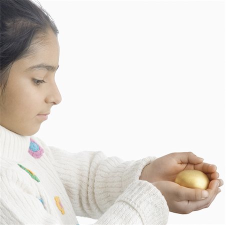 simsearch:630-02221120,k - Side profile of a girl holding an Easter egg Stock Photo - Premium Royalty-Free, Code: 630-02220349