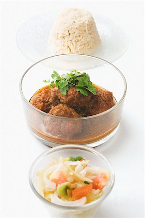 Close-up of meatballs in a bowl served with boiled rice and salad Stock Photo - Premium Royalty-Free, Code: 630-02220570