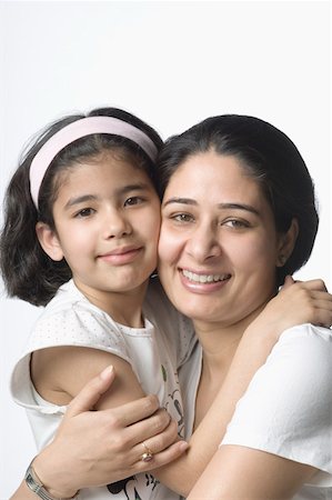 simsearch:630-02219943,k - Portrait of a girl hugging her mother and smiling Stock Photo - Premium Royalty-Free, Code: 630-02220705