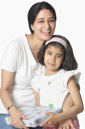 simsearch:630-02219943,k - Portrait of a mid adult woman giving a gift to her daughter Stock Photo - Premium Royalty-Free, Code: 630-02220702