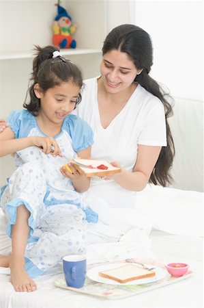 simsearch:630-02219943,k - Girl spreading jam on a bread with her mother Stock Photo - Premium Royalty-Free, Code: 630-02220703