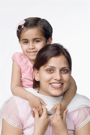 simsearch:630-02219943,k - Portrait of a mid adult woman smiling with her daughter Stock Photo - Premium Royalty-Free, Code: 630-02220764