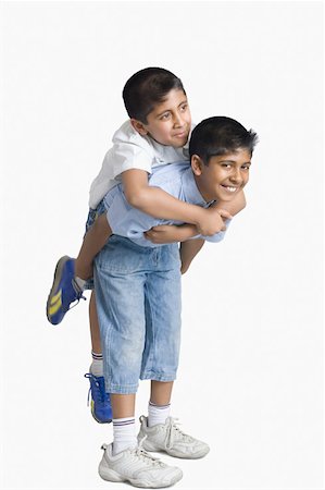 piggyback brothers - Boy riding piggyback on another boy Stock Photo - Premium Royalty-Free, Code: 630-02220769