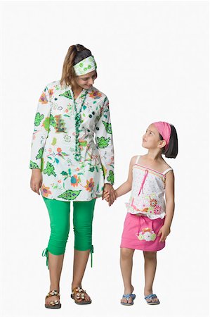 standing casual sandal - Young woman and her daughter holding each other's hands and looking at each other Stock Photo - Premium Royalty-Free, Code: 630-02220874