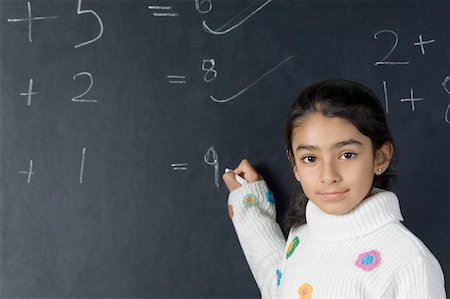 simsearch:625-01250891,k - Portrait of a girl solving mathematical symbols on a blackboard Stock Photo - Premium Royalty-Free, Code: 630-02220918