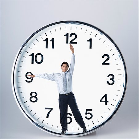 Businessman performing in a clock Stock Photo - Premium Royalty-Free, Code: 630-02220928