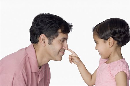 simsearch:630-02219943,k - Close-up of a girl touching her father's nose and smiling Stock Photo - Premium Royalty-Free, Code: 630-02220939