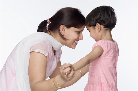 simsearch:630-02219943,k - Side profile of a mid adult woman holding hands of her daughter Stock Photo - Premium Royalty-Free, Code: 630-02220944