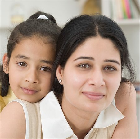 simsearch:630-02219943,k - Close-up of a girl hugging her mother from behind Stock Photo - Premium Royalty-Free, Code: 630-02221105