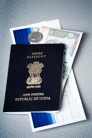 Close-up of an Indian passport with money and an airline ticket Stock Photo - Premium Royalty-Free, Code: 630-02221100