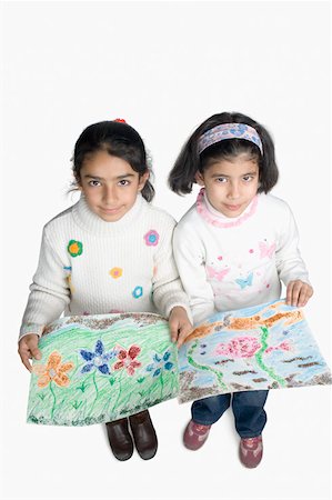 Portrait of two girls showing drawings Stock Photo - Premium Royalty-Free, Code: 630-02221122