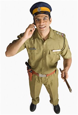 police officer full body - Portrait of a policeman talking on a mobile phone and smiling Stock Photo - Premium Royalty-Free, Code: 630-03479405