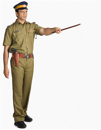 security officer picture - Policeman pointing forward with a nightstick Stock Photo - Premium Royalty-Free, Code: 630-03479402