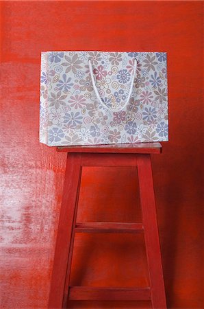 shopping bags closeup - Close-up of a shopping bag on a stool Stock Photo - Premium Royalty-Free, Code: 630-03479456