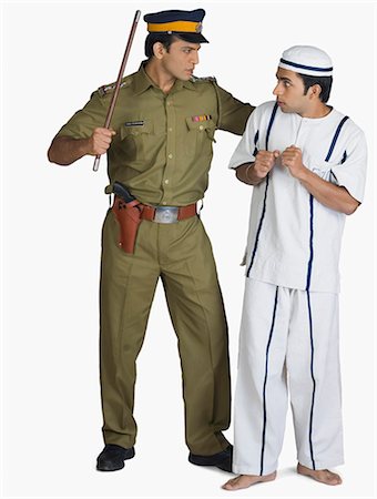security officer - Policeman arresting a prisoner Stock Photo - Premium Royalty-Free, Code: 630-03479481