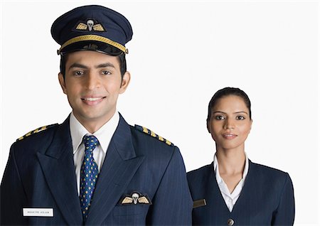 pilot - Portrait of a pilot with an air hostess Stock Photo - Premium Royalty-Free, Code: 630-03479527