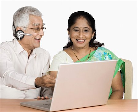 Senior man and a mature woman chatting online on a laptop Stock Photo - Premium Royalty-Free, Code: 630-03479599