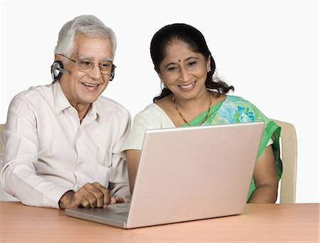 simsearch:630-03479683,k - Senior man and a mature woman chatting online on a laptop Stock Photo - Premium Royalty-Free, Code: 630-03479600