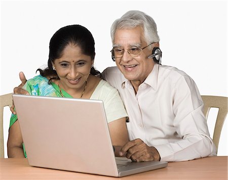 simsearch:630-03479740,k - Senior man and a mature woman chatting online on a laptop Stock Photo - Premium Royalty-Free, Code: 630-03479601
