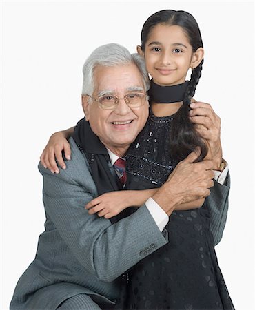 simsearch:630-03479740,k - Senior man hugging his granddaughter and smiling Stock Photo - Premium Royalty-Free, Code: 630-03479659