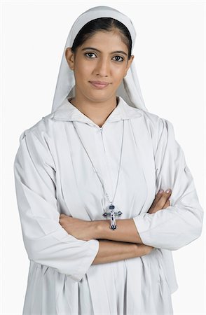 Portrait of a nun standing with her arms crossed Stock Photo - Premium Royalty-Free, Code: 630-03479665