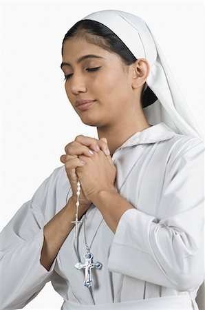 praying catholic nun - Close-up of a nun standing in the prayer position Stock Photo - Premium Royalty-Free, Code: 630-03479673