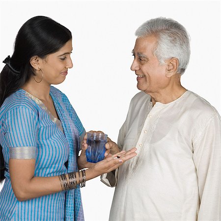 simsearch:630-03479683,k - Young woman giving medicine to her father Stock Photo - Premium Royalty-Free, Code: 630-03479745
