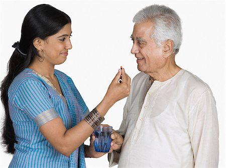 simsearch:630-03479683,k - Young woman giving medicine to her father Stock Photo - Premium Royalty-Free, Code: 630-03479746