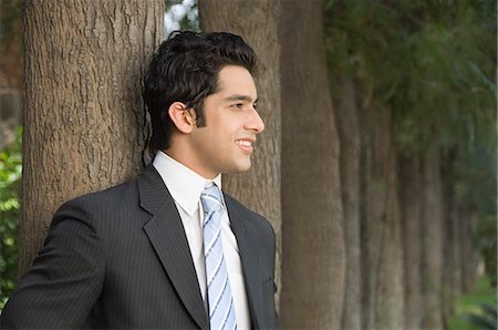 Businessman standing and smiling Stock Photo - Premium Royalty-Free, Code: 630-03479833