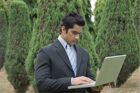 park laptop - Businessman working on a laptop Stock Photo - Premium Royalty-Free, Code: 630-03479873