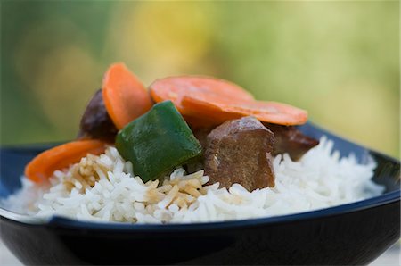 Close-up of meat with white rice in a bowl Stock Photo - Premium Royalty-Free, Code: 630-03480000