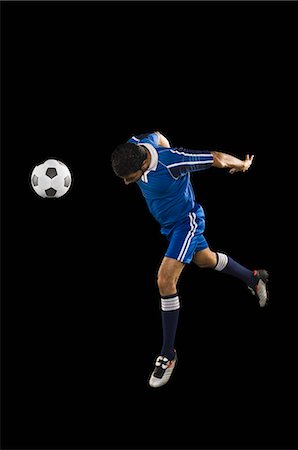 Man heading a soccer ball Stock Photo - Premium Royalty-Free, Code: 630-03480329