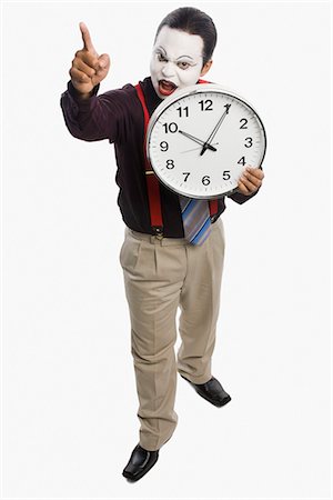 schedule - Mime showing a clock Stock Photo - Premium Royalty-Free, Code: 630-03480646