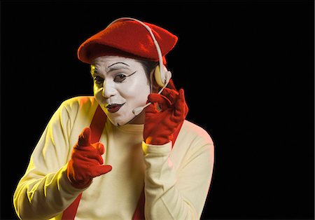 Portrait of a mime wearing headset Stock Photo - Premium Royalty-Free, Code: 630-03480701