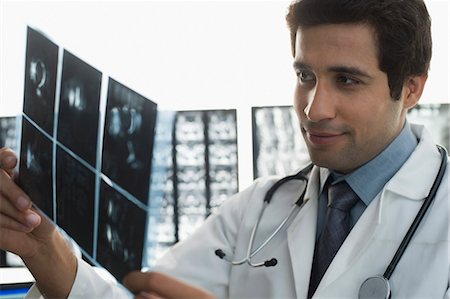simsearch:614-06897440,k - Male doctor examining an X-Ray report Stock Photo - Premium Royalty-Free, Code: 630-03480725