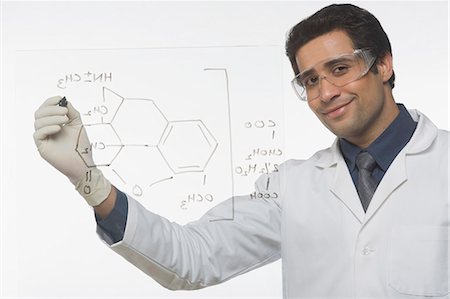 Scientist writing chemical formula Stock Photo - Premium Royalty-Free, Code: 630-03480810