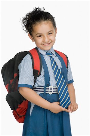 schoolbag - Portrait of a schoolgirl carrying a schoolbag and smiling Stock Photo - Premium Royalty-Free, Code: 630-03481144