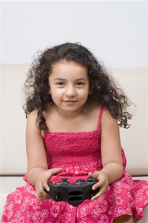 simsearch:6108-06905230,k - Portrait of a girl playing a video game Stock Photo - Premium Royalty-Free, Code: 630-03481221